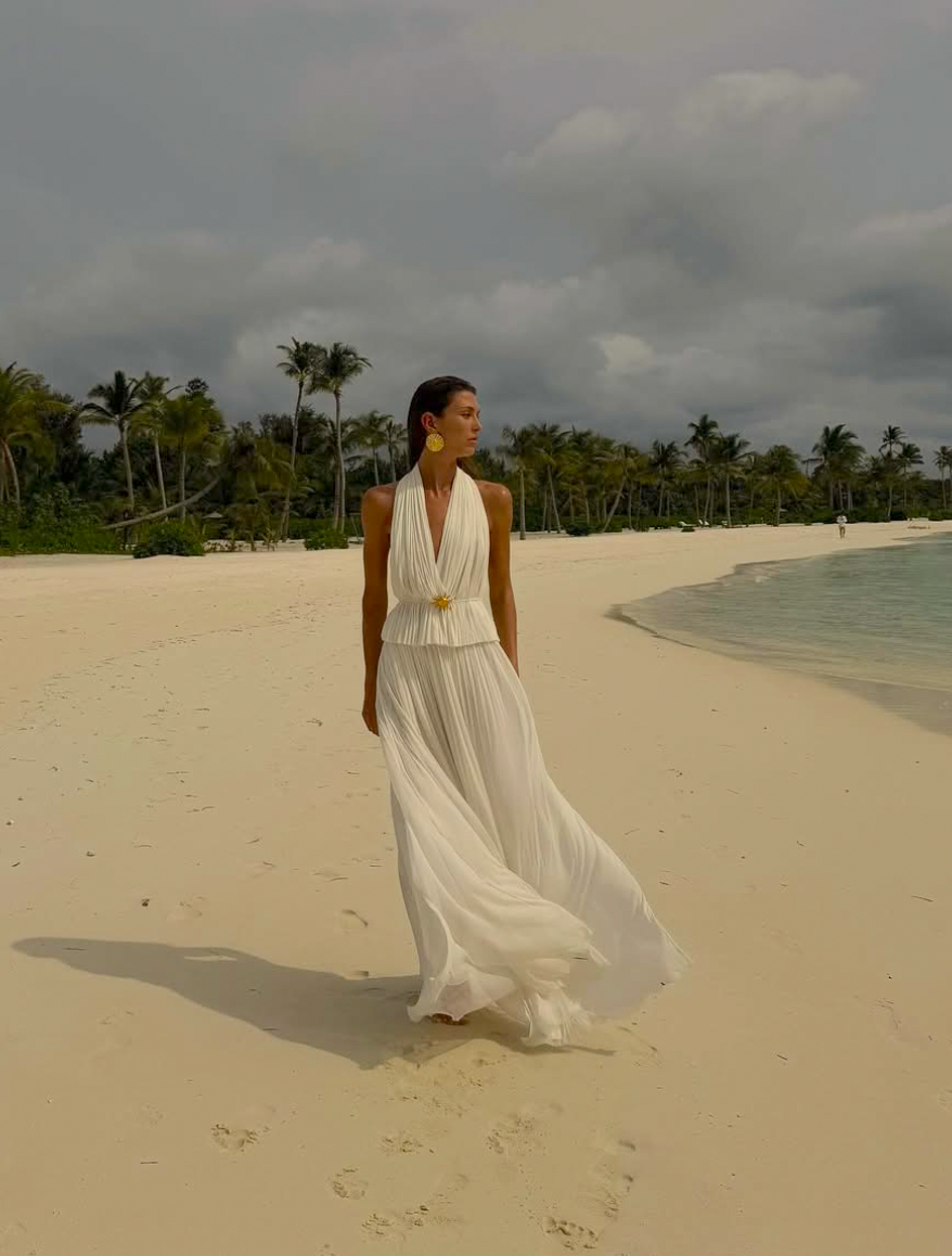 Indulge in luxury with the White Silk Skirt and Top Set. Made of the finest double layered Silk Tulle, this set exudes elegance and quality. With a hidden elastic waist, the skirt offers a perfect fit while the top adds a touch of delicacy. Perfect for any special occasion.