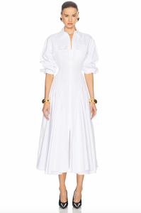 Elevate your style with the luxurious Godet Shirt Dress by Helsa. Made from premium poplin, this partially lined dress boasts a flattering fit and flare silhouette. With buttoned cuffs, front button closure, and flap pockets, it's a sophisticated and elegant must-have for your wardrobe.