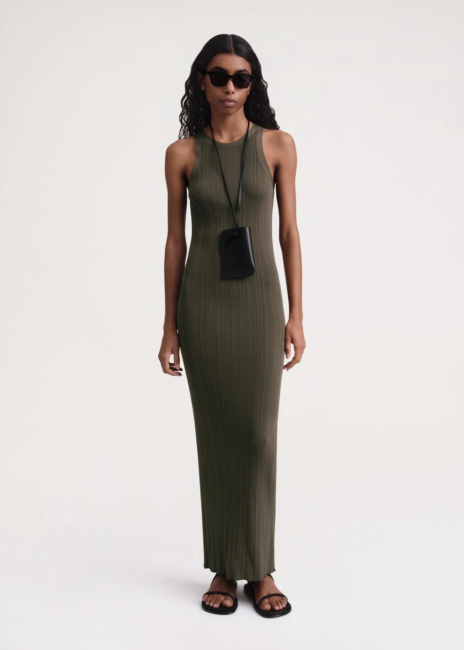 Elevate your style game with our TOTEME Khaki Seamless Midi Dress. Made from a luxurious rib knit blend of viscose and recycled nylon, this dress molds to your body for a flawless fit. Perfect for any occasion, this dress exudes sophistication and exclusivity.