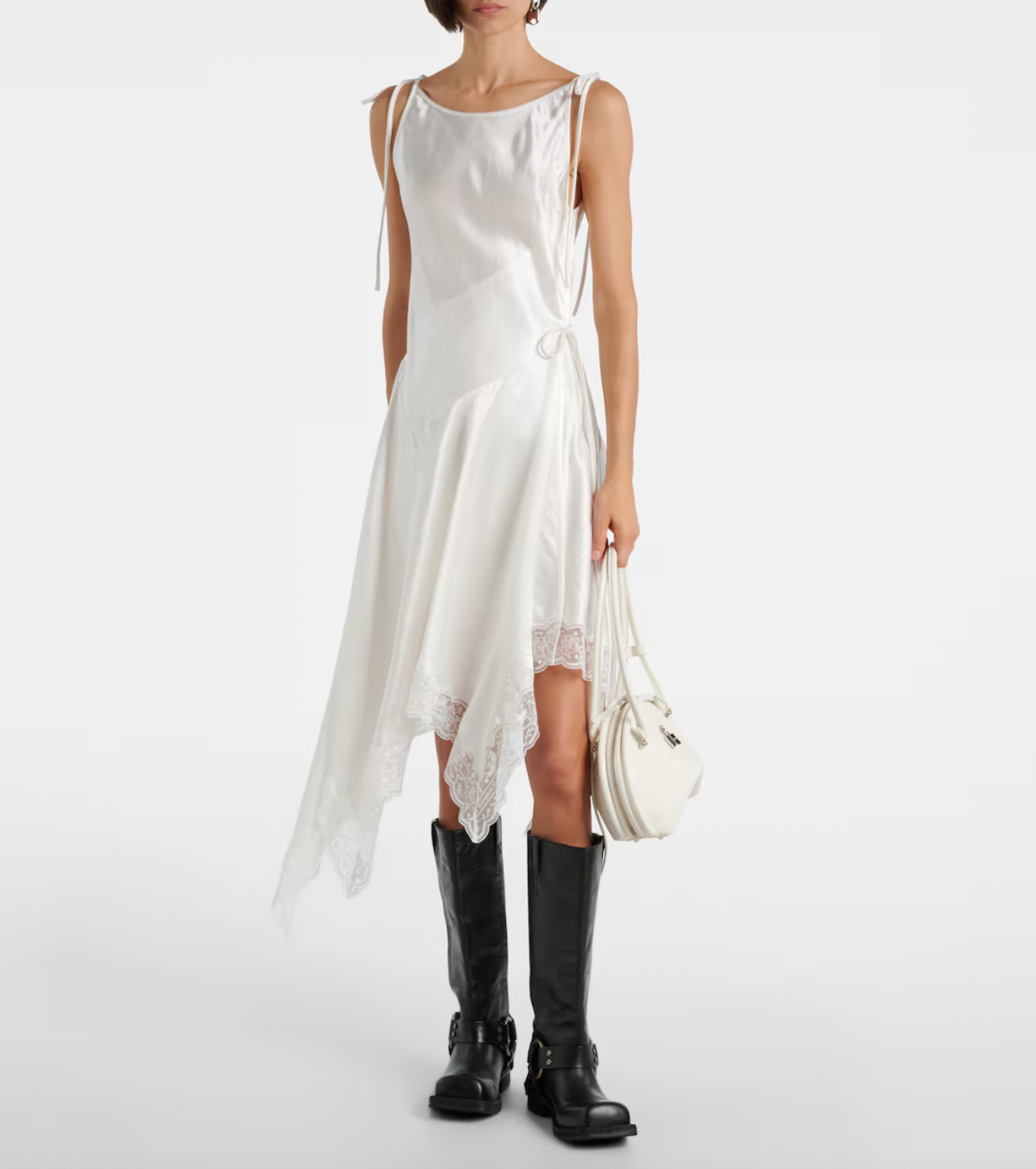 Embrace understated elegance with this satin minidress from Stockholm’s Acne Studios. Its smooth fabric skims the body while delicate lace trims add a feminine touch to the asymmetric hem, creating a modern yet romantic silhouette. Perfect for making a subtle statement, this dress effortlessly blends Scandinavian cool with alluring detail.