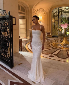 Experience elegance and allure with the expertly-crafted Abella Dress. Its stunning fishtail silhouette, intricate backless detail, and beautiful white lace make it perfect for any bride wanting to make a statement on her special day. Turn heads and feel confident in this timeless and elegant dress.