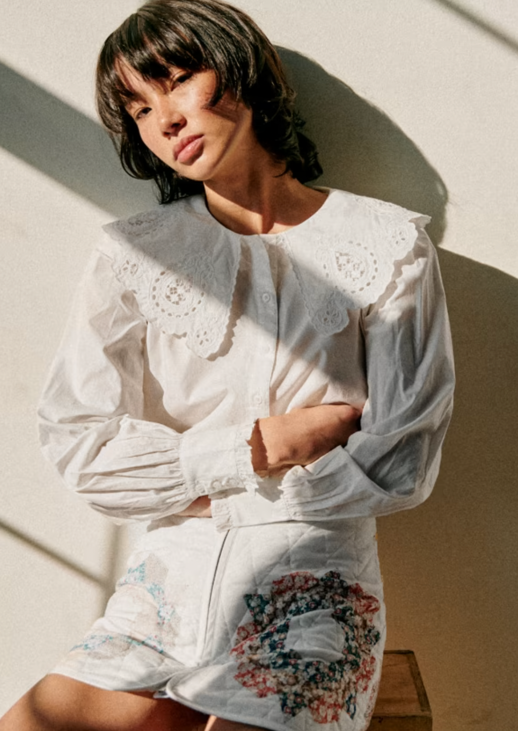 The Flavie Shirt by Sezane combines timeless elegance with a standout design featuring a large embroidered collar that adds a touch of sophistication to your look. Its long sleeves and buttoned front offer both comfort and versatility, making it perfect for dressing up or down. Elevate your wardrobe with this statement piece that effortlessly blends classic style and unique detail.