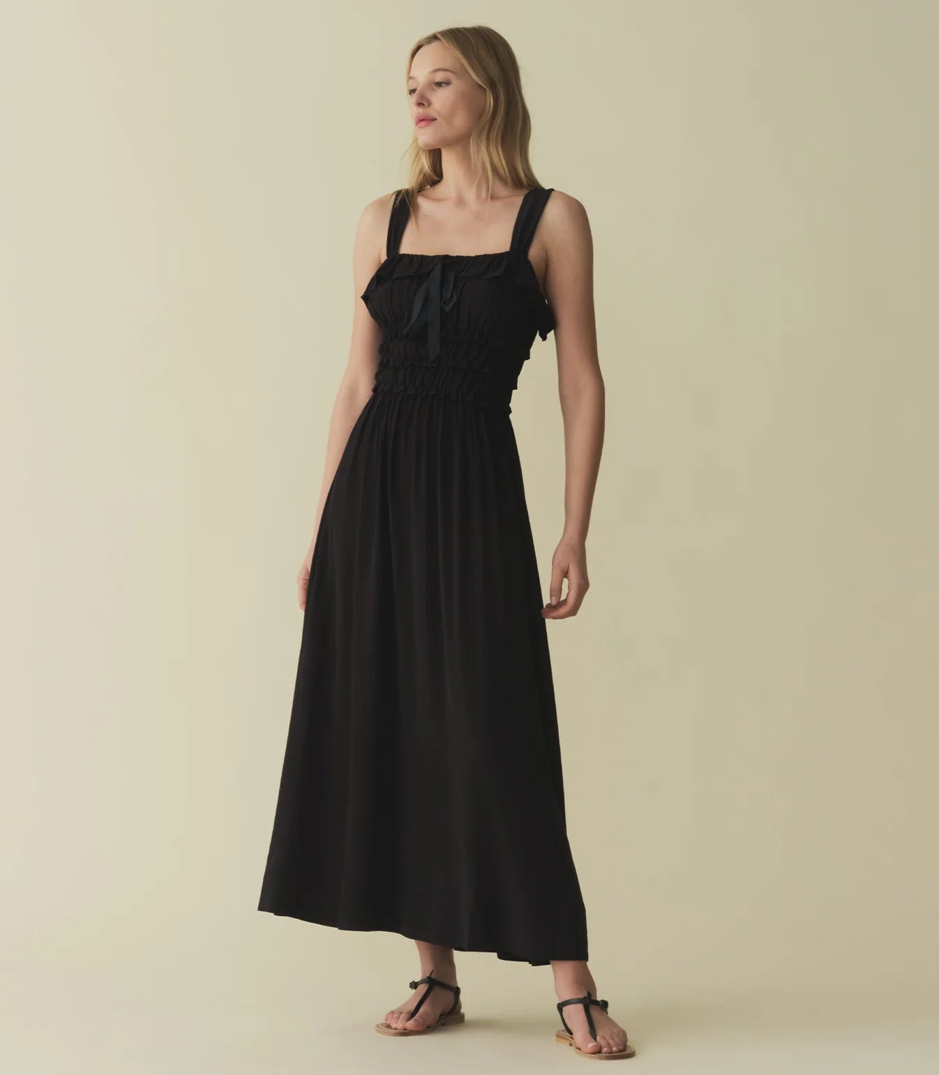 The Carolynn Dress—in a lightweight blend of rayon and viscose—features a square neckline, a gathered bust, and a fitted bodice framed with petite ruffles. Elastic lends give to the bust and waist, giving way to a swingy, ankle-length skirt.