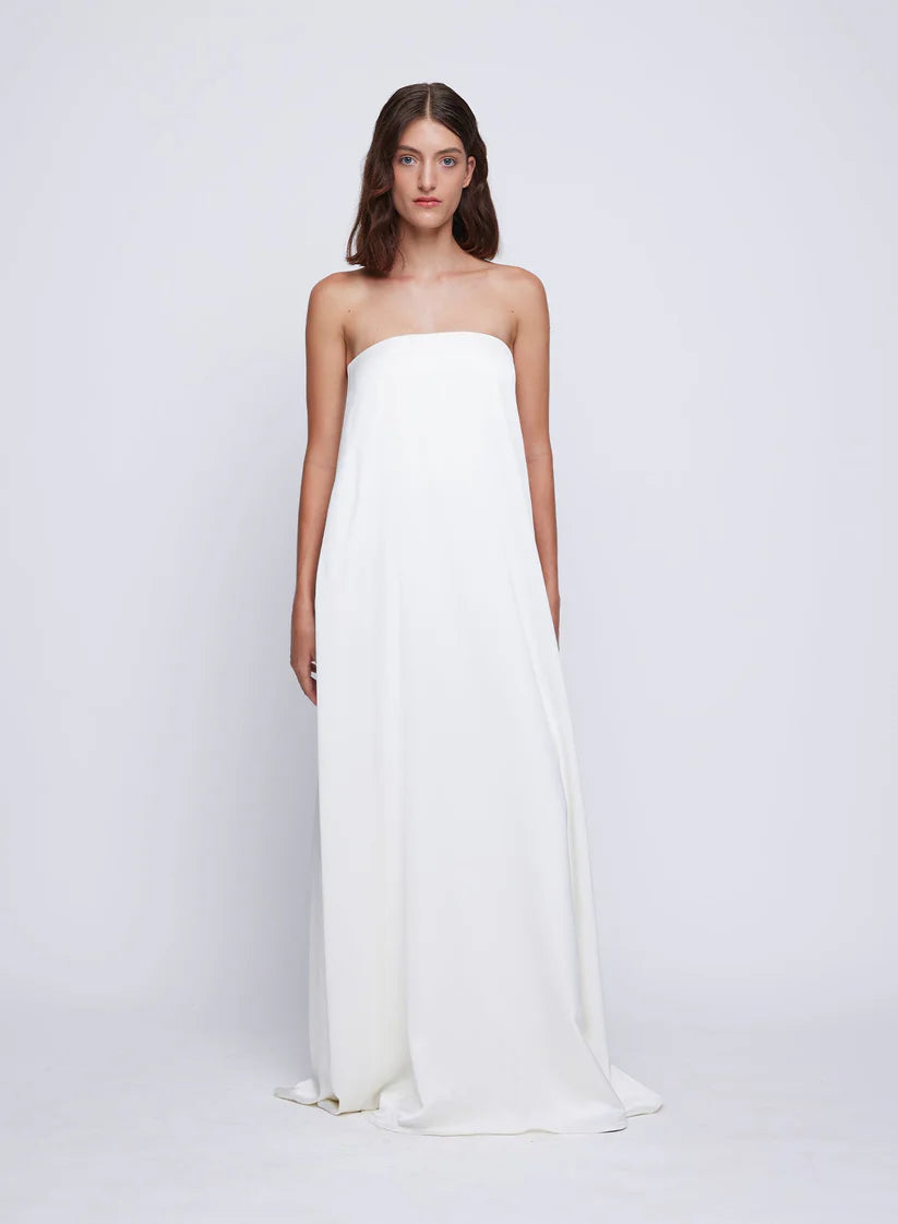 The Delfina Dress in Ivory is a timeless occasion piece to keep in your wardrobe for years to come. Showcasing a feminine strapless silhouette and internal bodice for support and ease of wear. Cut in a soft silky feel fabrication and completed with side pockets.&nbsp; This dress can be styled for summer day time events or more formal evening events.