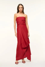 Load image into Gallery viewer, Unleash your daring side with the Caravaggio Dress Rouge by STAUD! This luxurious maxi dress, crafted from a silk wool blend, drapes elegantly and offers structural support with its built-in corset. Perfect for any adventure, this dress combines ease and sophistication. Embrace the challenge and stand out in style!
