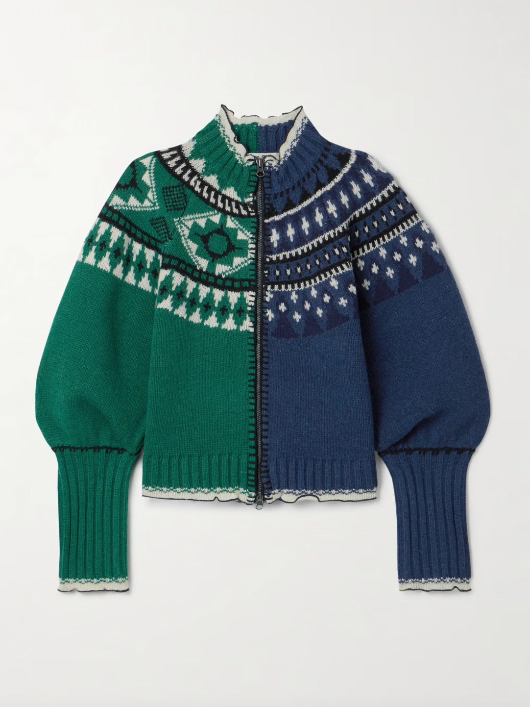 Sea's Linea cardigan masterfully blends two distinct aesthetics into one captivating piece. Crafted from sumptuous merino wool, this intarsia-knit design features Fair Isle-inspired motifs that create visual intrigue, while delicate ruffled trims add an unexpected feminine touch. The clever split construction gives the illusion of contrasting styles sewn together, making it a conversation-starting layer that transforms any basic turtleneck into an effortlessly sophisticated ensemble. 