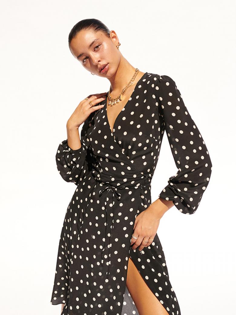 Get ready to turn heads with The Violette dress! With its classic black and white spotted print, this dress adds a touch of sophistication to any look. Made with high-quality materials for comfort and style, it's perfect for a night out or a day at the office.