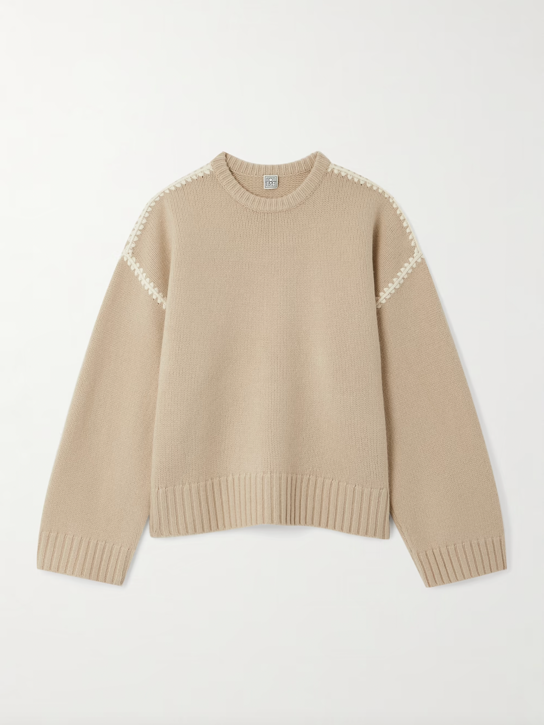 Elevate your wardrobe with this oversized sweater by Toteme crafted from a sumptuous wool and cashmere blend. Its relaxed fit with dropped shoulders offers effortless comfort, while the contrasting cream embroidery adds a refined, distinctive touch. Designed as a timeless staple, it seamlessly enriches your collection, providing both warmth and style for any occasion.