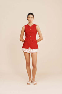 The Matilda Gilet, crafted from 100% linen in a striking red, combines elegance with versatility. Its jewel neckline and flared peplum hem create a refined silhouette, while the adjustable gold buckle at the back allows precise waist customization. Functional welt pockets feature delicate ruffle flaps that can be displayed for added style or concealed for a clean finish. Fully lined with a curved hemline and centre back split, this gilet offers both comfort and tailored sophistication for a polished look.