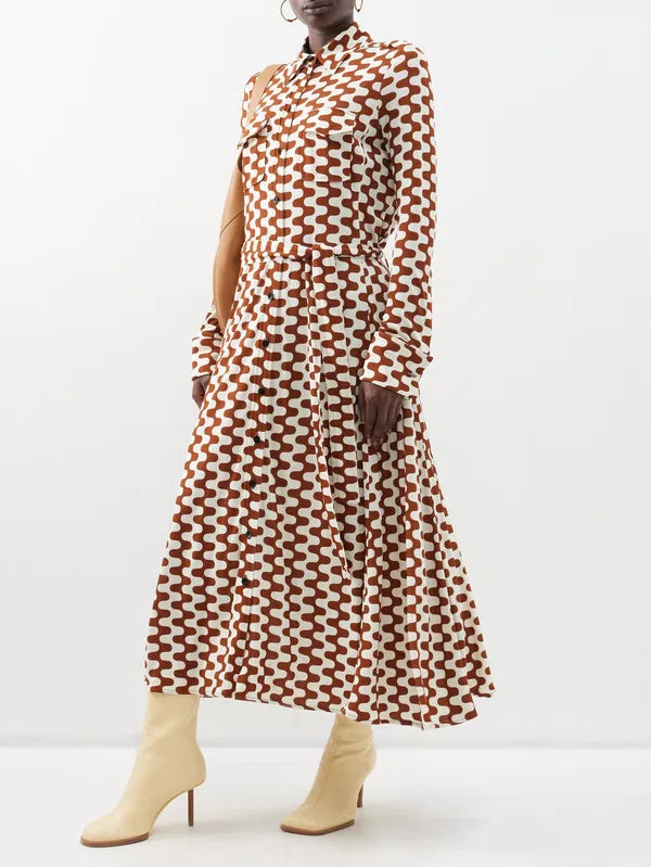 Embrace retro chic with Proenza Schouler's Printed-Jersey Maxi Shirt Dress. The brown and cream zigzag motif adds a playful touch to this sophisticated dress, made from comfortable jersey with a flattering tie-back waist and elegant fold French cuffs. Elevate your wardrobe with this exclusive piece.