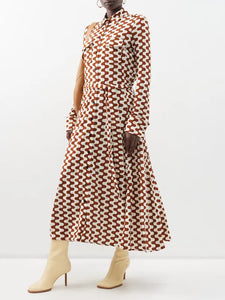 Embrace retro chic with Proenza Schouler's Printed-Jersey Maxi Shirt Dress. The brown and cream zigzag motif adds a playful touch to this sophisticated dress, made from comfortable jersey with a flattering tie-back waist and elegant fold French cuffs. Elevate your wardrobe with this exclusive piece.