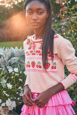 Load image into Gallery viewer, The Renton Pullover is a charming blend of cotton and wool, adorned with a delightful strawberry and cherry motif. Hand-crocheted strawberries add a touch of whimsy. With a shrunken fit and ribbed neckline, cuffs, and border, this sweater is both cozy and stylish. Adorned with strawberry buttons down the back, it&#39;s the perfect addition to any wardrobe.
