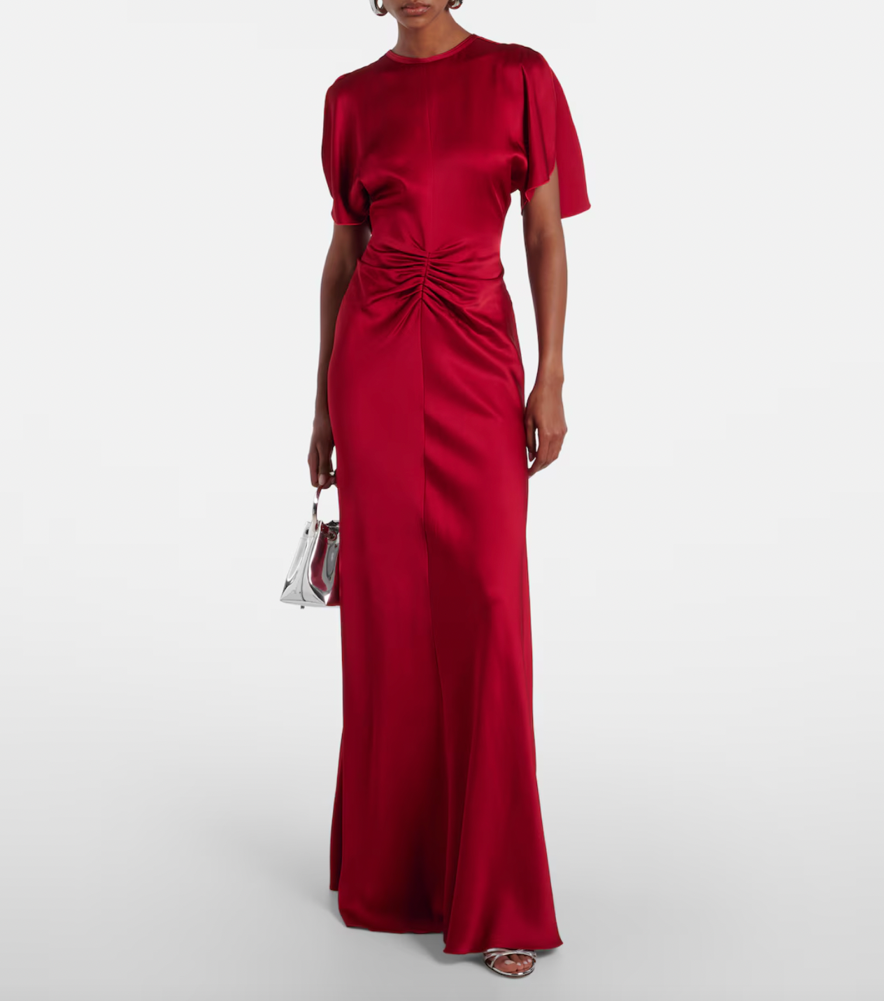 Stunning in vibrant red crêpe satin, this Victoria Beckham gown masterfully balances elegance with edge. Dramatic cape shoulders provide modest coverage while the daring open back commands attention—a sophisticated contrast that turns heads. Expertly gathered detailing sculpts a flattering hourglass silhouette, making this the perfect statement piece for unforgettable evenings. Timeless design meets modern allure.