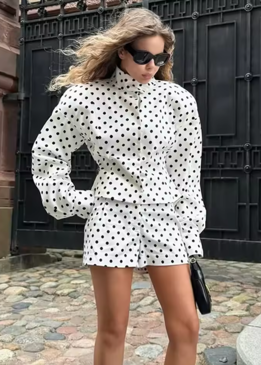 Elevate your casual wardrobe with the Delilah Jacket, a striking two-piece polka dot set that effortlessly blends style and comfort. Featuring a commanding stand collar jacket paired with coordinating shorts, this ensemble delivers the perfect balance of relaxed sophistication and contemporary edge. Long sleeves and a thoughtfully relaxed silhouette create an undeniably chic silhouette that works as hard as you do—whether you're running weekend errands or stepping out for an evening. 