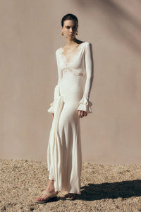 The Electra Maxi Dress combines elegant lace and a flattering fitted silhouette to create a captivating look. Its deep V lace neckline and delicate cut-outs add a touch of allure, while the cascading front-side tie drape enhances graceful movement. Flared layered sleeves bring a vintage charm, and the partial lining ensures comfort without compromising style. Perfect for making a memorable impression at any evening event, this dress shapes a sophisticated and sultry statement.