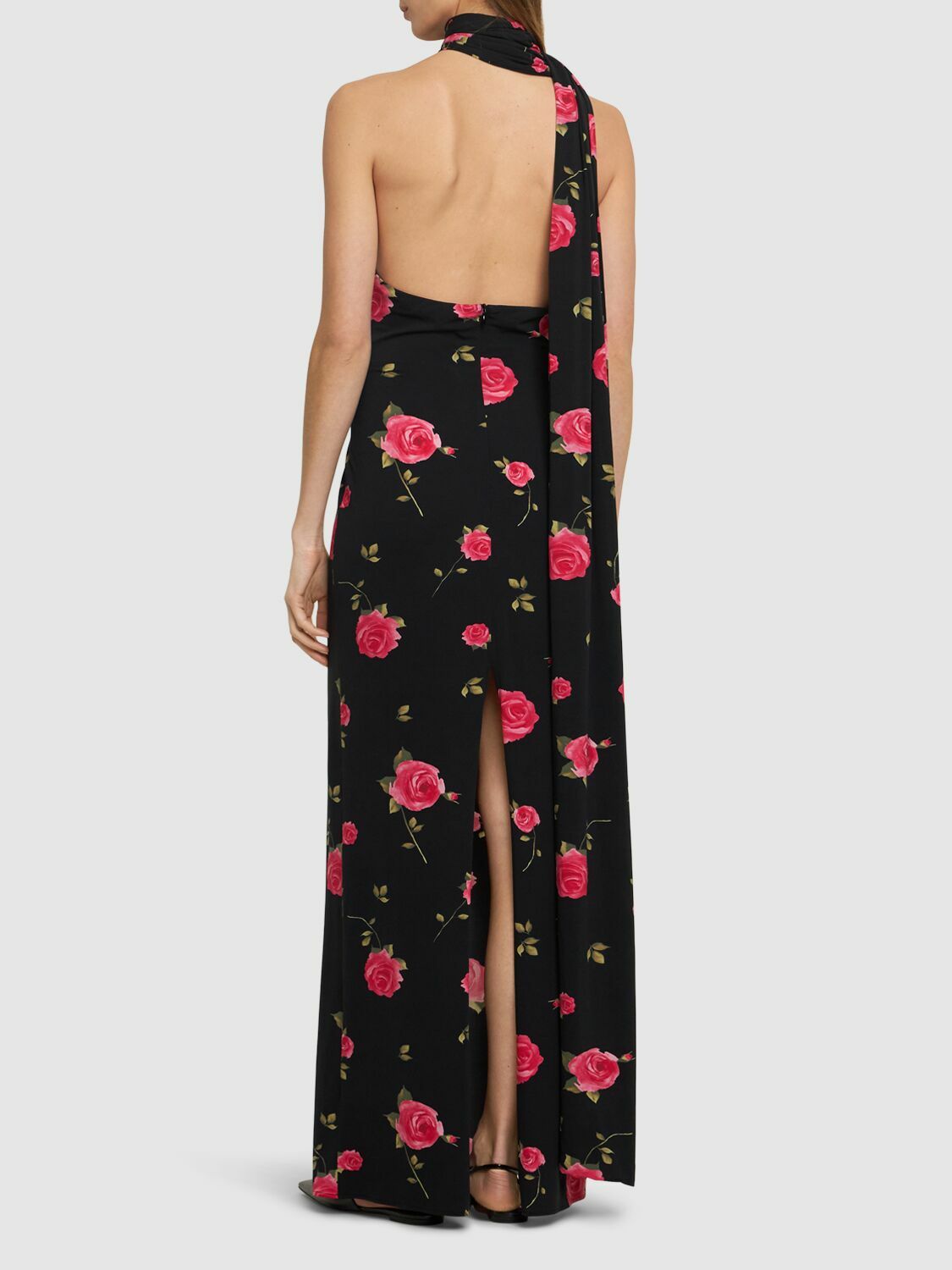 Introducing the luxurious Rose Print Jersey Long Dress by Magda Butrym. This stunning dress features a back zip closure and center back slit for ease of wear and a flattering silhouette. The non-detachable scarf panel adds a touch of elegance and the all over print placement may vary, making each dress unique. Elevate your wardrobe with this must-have piece.