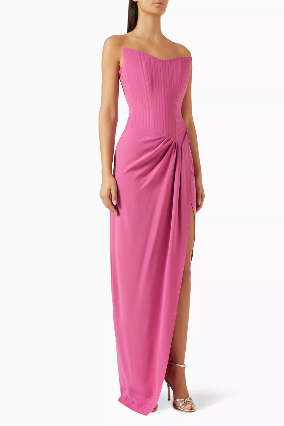 The Corset Asymmetrical Drape Gown in Crepe by Alex Perry is your answer to effortless elegance. Sculpted from luxurious crepe, the structured corset bodice flatters your silhouette while the asymmetrical draping creates an understated, sophisticated statement. Whether you're attending a wedding reception, gala, or black-tie event, this gown delivers timeless glamour without demanding excess. 