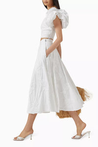 Elevate your wardrobe with this expertly crafted high-waisted maxi skirt by Rotate Birger Christensen, designed in sustainable organic cotton. Its voluminous, flared silhouette offers graceful movement, while tonal floral embroidery enriches the texture with subtle, refined detail. Thoughtful tailoring, including soft gathering at the waistband and a discreet side zipper, guarantees a smooth, flattering fit tailored for lasting comfort and style. 