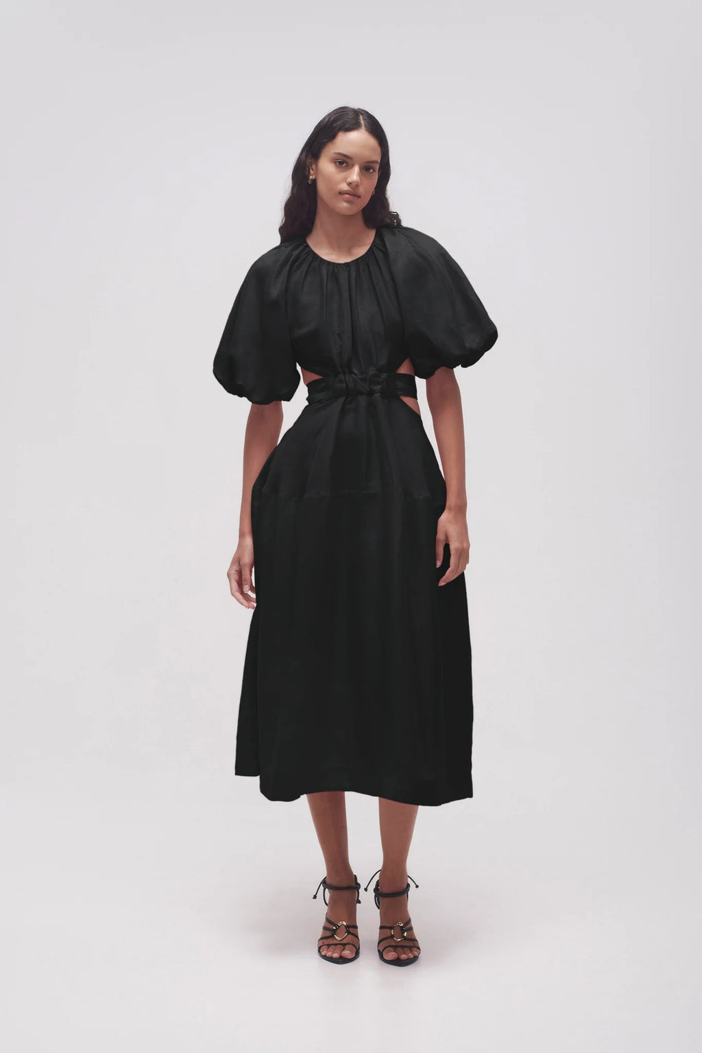 It's hard to resist the charm of Aje's 'Mimosa' dress silhouette. Made from a lightweight linen blend with a cotton lining for added opacity, the dress includes puffed sleeves, a fitted bodice, and waist cutouts. Easily pair it with mules or strappy sandals for a stylish look.