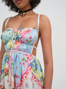 Introducing the Cassandra Midi Dress by For Love & Lemons, your must-have for a nostalgic festival look. This blue apron dress is inspired by patchwork quilts and handkerchiefs found at Grandma's house, and features scrunchy straps, a ruched bodice, and a charming rosette. Rock it and relive the good ol' days.