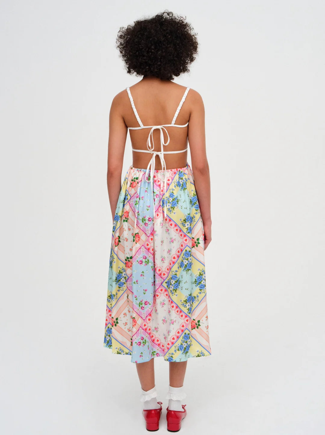 Introducing the Cassandra Midi Dress by For Love & Lemons, your must-have for a nostalgic festival look. This blue apron dress is inspired by patchwork quilts and handkerchiefs found at Grandma's house, and features scrunchy straps, a ruched bodice, and a charming rosette. Rock it and relive the good ol' days.