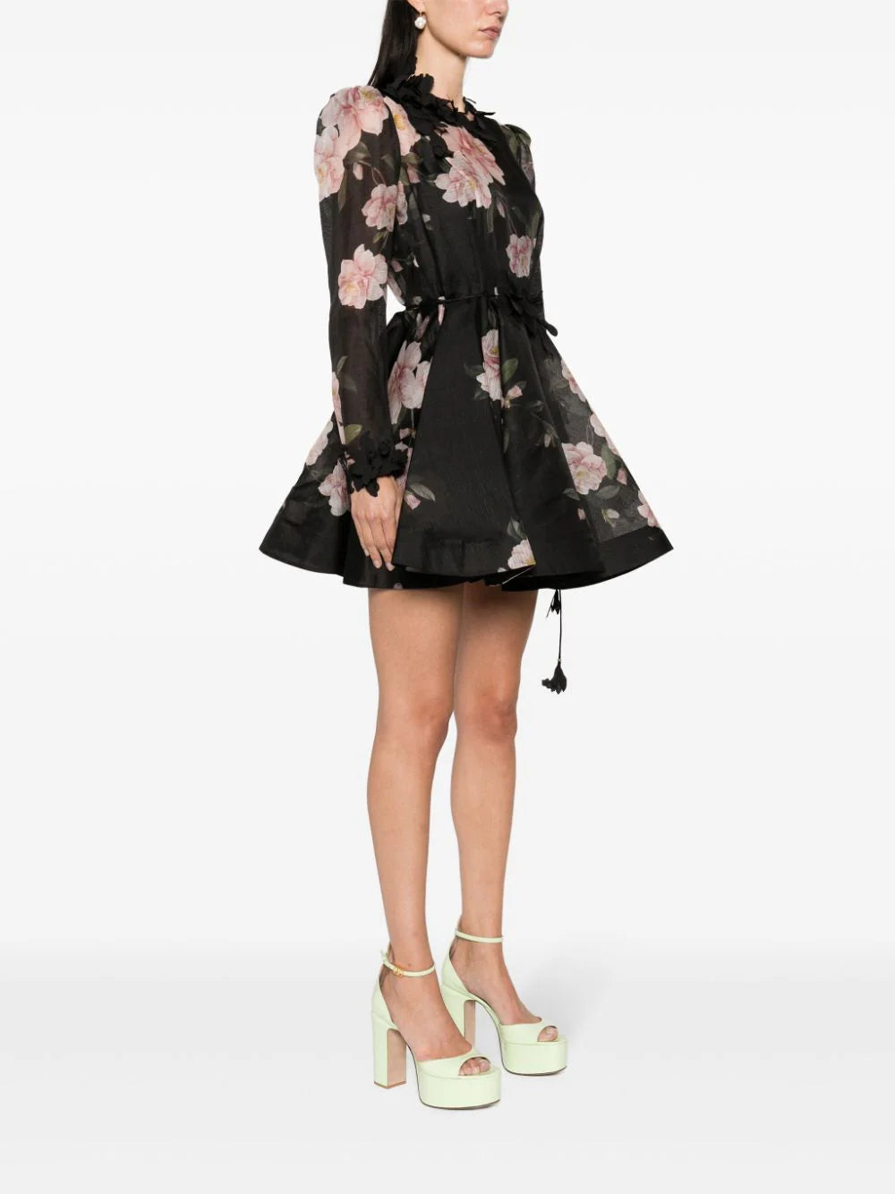 Indulge in the beauty of our Natura Mini Dress. Crafted with a semi-sheer, recycled polyester blend, this black dress features a stunning floral print, 3D detailing, and floral appliqué. The round neck, long sleeves, and tied waist create a flattering silhouette, while the pleated skirt adds a touch of elegance. Feel confident and stylish in this sustainable and versatile piece.