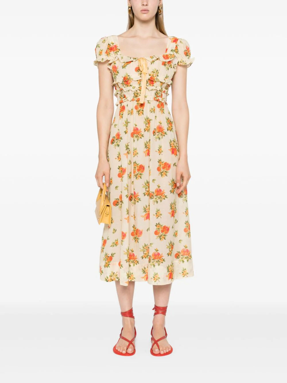 Introducing the Clarine Midi Dress, crafted from an organic cotton blend for a luxurious touch. Its stunning floral print, ruffled details, and bow embellishments add a touch of sophistication. Featuring a square neck, short puff sleeves, and a smocked waist, this slip-on style dress embodies elegance and femininity.