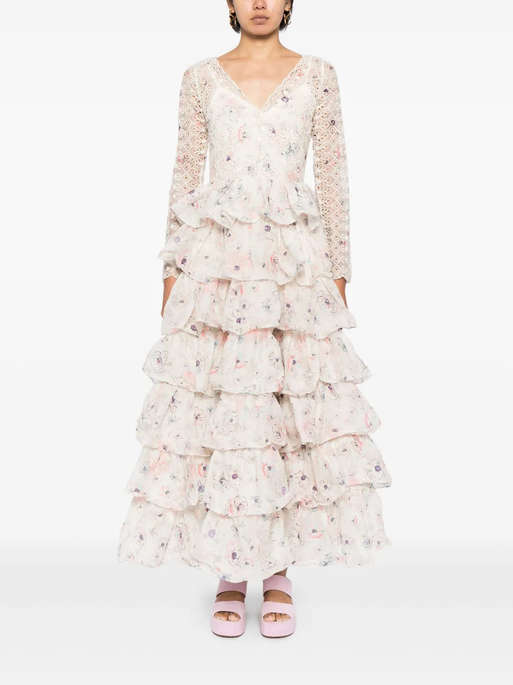 The Halliday floral-print gown from ZIMMERMANN combines delicate broderie anglaise cotton with a layered, tiered skirt for graceful movement. Its all-over floral print and ruffled detailing add feminine charm, while the fitted waistline and V-neck enhance your silhouette. Long sleeves and a concealed rear zip provide a comfortable, elegant fit. Ankle-length with a ruffle hem, this gown is perfect for making a lasting impression at any special occasion.