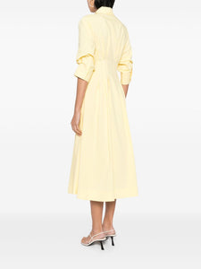 Introducing the Simkhai Jazz Midi Dress in a striking sulfur yellow. Made with a comfortable cotton blend, this dress features pintuck detailing and a straight-point collar. The three-quarter length puff sleeves and flared skirt add a touch of femininity. With a concealed front button fastening, buttoned-cuff sleeves, and two side inset pockets, this dress is both functional and stylish. Complete with full lining and a midi-length straight hem, this dress is perfect for any occasion.