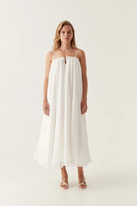 Introducing the Filigree Sweetheart Midi Dress by AJE, the epitome of elegance and luxury. Designed with a relaxed fit and adjustable straps, this dress effortlessly flatters your silhouette. The wired curve neckline and whipstitch details add a touch of sophistication, while the voluminous smock skirt and permanent plissé pleating throughout create a whimsical flow.