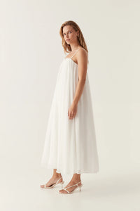 Introducing the Filigree Sweetheart Midi Dress by AJE, the epitome of elegance and luxury. Designed with a relaxed fit and adjustable straps, this dress effortlessly flatters your silhouette. The wired curve neckline and whipstitch details add a touch of sophistication, while the voluminous smock skirt and permanent plissé pleating throughout create a whimsical flow.
