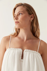 Introducing the Filigree Sweetheart Midi Dress by AJE, the epitome of elegance and luxury. Designed with a relaxed fit and adjustable straps, this dress effortlessly flatters your silhouette. The wired curve neckline and whipstitch details add a touch of sophistication, while the voluminous smock skirt and permanent plissé pleating throughout create a whimsical flow.