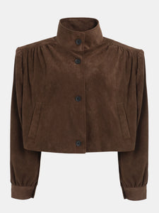 This ruched suede bomber jacket combines classic style with modern details. Its boxy shape and padded shoulders give a confident edge, while the stand collar and gathered pleats add subtle sophistication. The softly structured waistband offers a gentle blouson effect, creating a relaxed yet polished silhouette. Fully lined for comfort, this jacket is perfect for elevating any outfit with effortless charm.