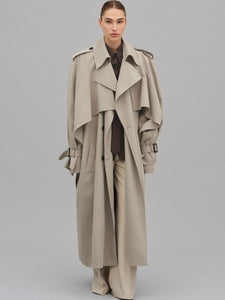 This Caped Trench Coat elevates the traditional silhouette with voluminous cape-like accents draped from the shoulders and sleeves, blending architectural boldness with classic refinement. Fully lined for a polished finish, it offers both visual impact and lasting comfort, making it a sophisticated addition to any wardrobe.
