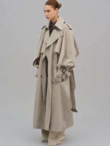This Caped Trench Coat elevates the traditional silhouette with voluminous cape-like accents draped from the shoulders and sleeves, blending architectural boldness with classic refinement. Fully lined for a polished finish, it offers both visual impact and lasting comfort, making it a sophisticated addition to any wardrobe.