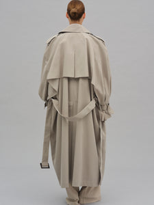 This Caped Trench Coat elevates the traditional silhouette with voluminous cape-like accents draped from the shoulders and sleeves, blending architectural boldness with classic refinement. Fully lined for a polished finish, it offers both visual impact and lasting comfort, making it a sophisticated addition to any wardrobe.