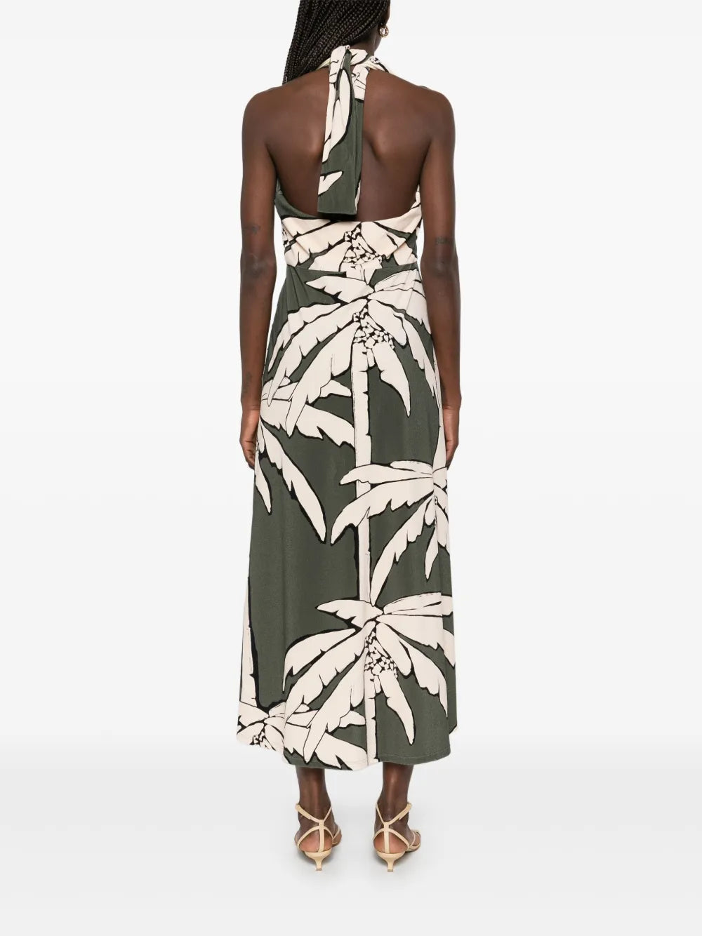 The Oceanic Mantra midi dress by Johanna Ortiz features an elegant olive green hue complemented by a halterneck design with a distinctive crossover strap detail, offering both comfort and visual interest. Its straight hemline creates a sleek silhouette, making it a sophisticated choice for elevated daytime or evening occasions.