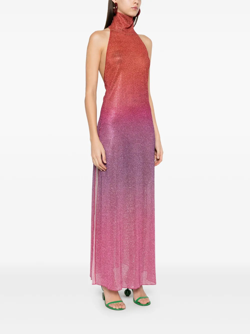 Elevate your wardrobe with this Italian-made Lurex midi dress, featuring a sophisticated dark pink hue and a subtle ombré effect. The halterneck design enhances your neckline, while the side slit adds a touch of allure and ease of movement. Crafted unlined for lightweight comfort, this dress combines elegance with contemporary style, perfect for refined occasions.