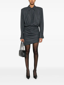 The Narine mini dress by Retrofete features a sophisticated charcoal and light grey pinstripe pattern, crafted with expert tailoring. It includes a concealed front button fastening and side zip for a seamless look, while shoulder pads and ruched detailing add structured elegance. The dress is finished with a pointed flat collar, long sleeves with buttoned cuffs, a straight hem, and full lining for comfort and quality. Ideal for those seeking a refined, modern silhouette with subtle detailing.