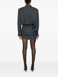 The Narine mini dress by Retrofete features a sophisticated charcoal and light grey pinstripe pattern, crafted with expert tailoring. It includes a concealed front button fastening and side zip for a seamless look, while shoulder pads and ruched detailing add structured elegance. The dress is finished with a pointed flat collar, long sleeves with buttoned cuffs, a straight hem, and full lining for comfort and quality. Ideal for those seeking a refined, modern silhouette with subtle detailing.