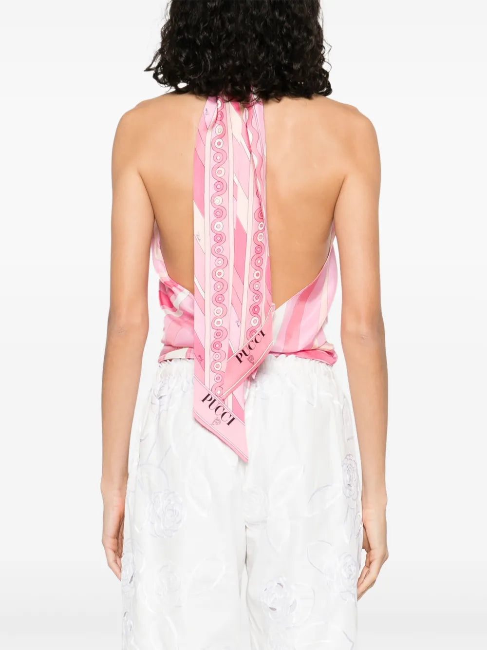 This top from Pucci showcases the brand’s signature Marmo motif rendered in bold, psychedelic prints with vibrant palettes. Crafted from luxurious silk, it offers a smooth, lustrous finish that enhances the rich colors. The elegant halter neckline adds a refined silhouette, making it a standout piece that combines artistic design with sophisticated wearability.