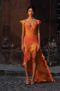 Experience luxury with our Dress Sunset. Made from hand painted silk burn-out chiffon, this dress is one of a kind. Each dress is unique due to the hand painted fabric, making it a true work of art. Elevate your wardrobe with this exclusive and elegant piece.