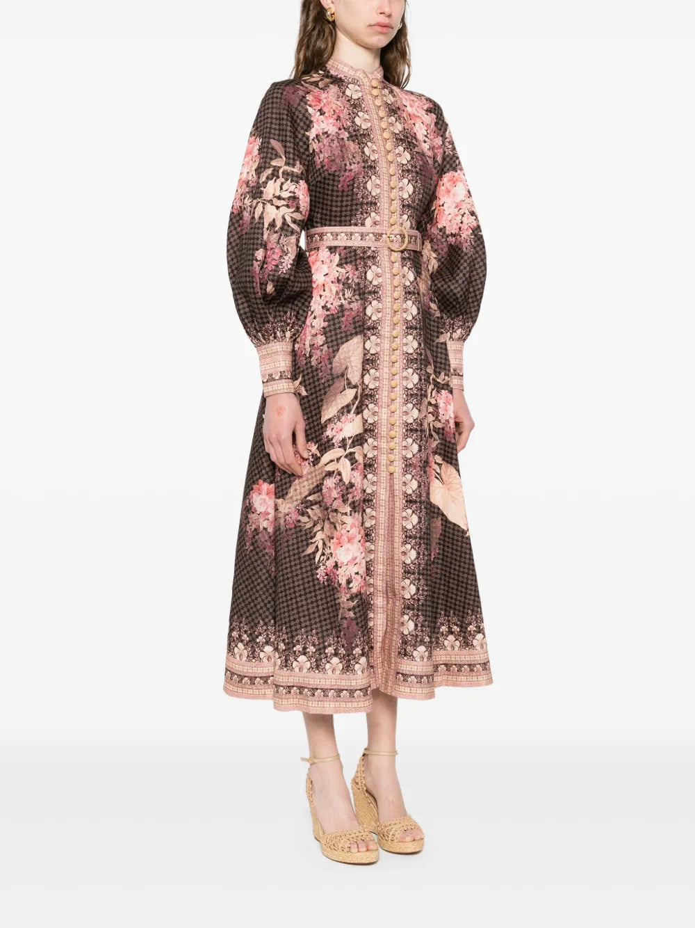 Experience effortless elegance with the Illuminate Linen Dress by Zimmermann. Crafted in breathable black linen, this dress features a delicate floral motif and a flattering front button fastening for easy wear. Long sleeves with buttoned cuffs add sophistication, making it perfect for both day and evening occasions. Embrace timeless style and comfort in this versatile piece that elevates your wardrobe with subtle charm.