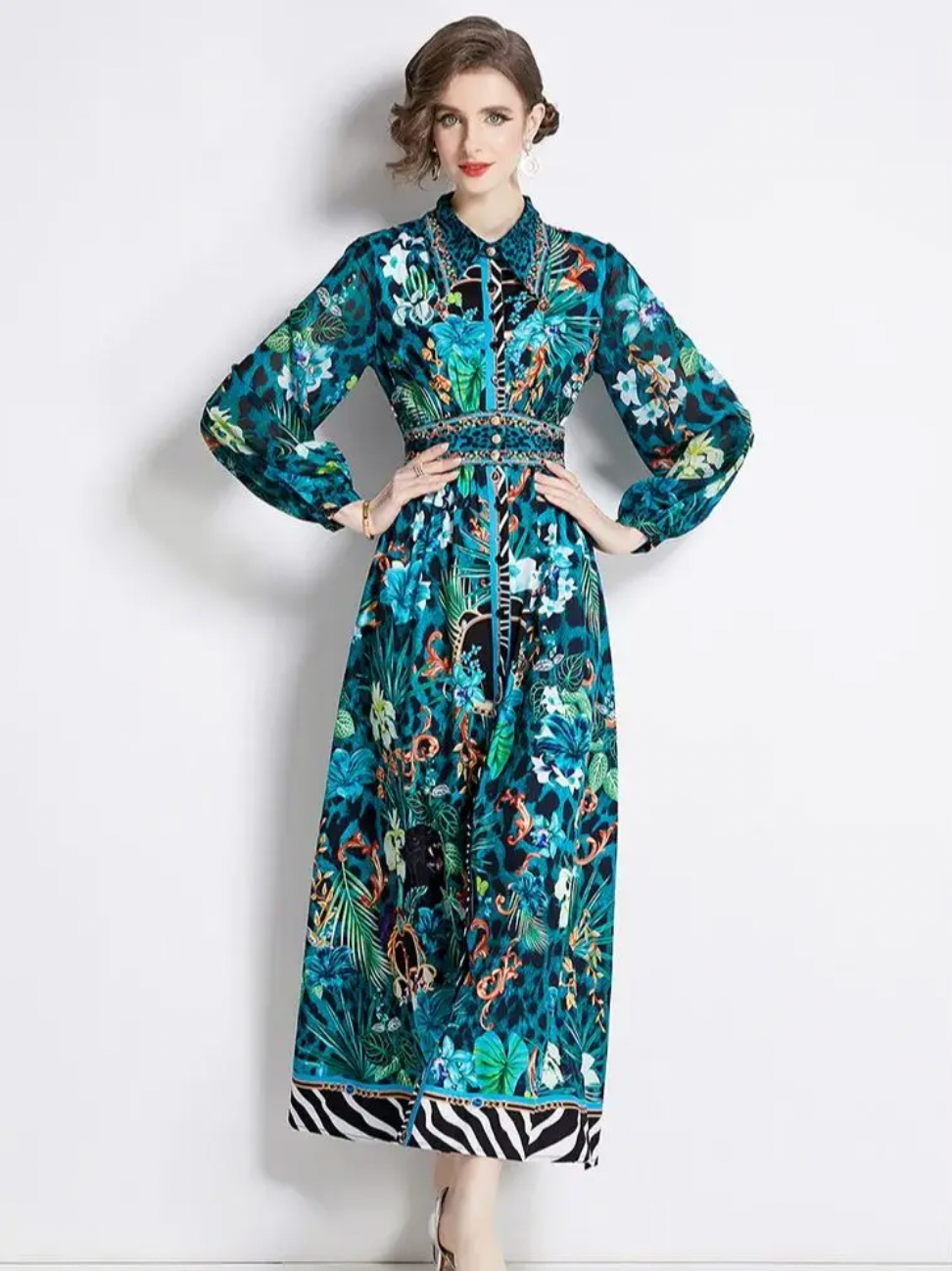 The Robe Nora is a trendy and elegant maxi dress, perfect for any occasion. Its soft green floral design adds a touch of femininity, while the turn down collar and long sleeves provide a sophisticated look. With the added feature of buttons, this dress is as functional as it is fashionable. Elevate your wardrobe with this versatile and stylish piece.