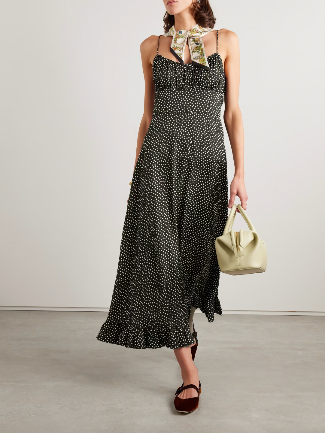 DÔEN's Rosaria midi dress elegantly combines form and detail with its polka-dot silk-blend fabric. Designed with precisely placed panels, it accentuates the silhouette by creating a subtle 'V' shape at the waist, enhancing your natural curves. The gathered bust paired with delicate pin-thin shoulder straps offers refined support while the ruffled hem adds graceful movement, making it a sophisticated choice for any occasion.