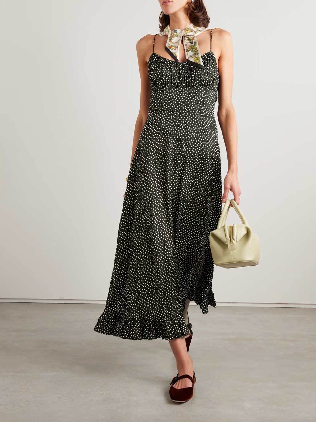 DÔEN's Rosaria midi dress elegantly combines form and detail with its polka-dot silk-blend fabric. Designed with precisely placed panels, it accentuates the silhouette by creating a subtle 'V' shape at the waist, enhancing your natural curves. The gathered bust paired with delicate pin-thin shoulder straps offers refined support while the ruffled hem adds graceful movement, making it a sophisticated choice for any occasion.