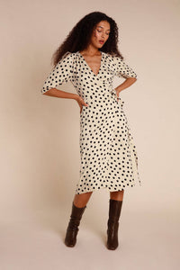 Introducing the Robe Caitlin - a stylish and versatile addition to your wardrobe. This knee-length jacquard dress features a wrap design, puffed sleeves, button accents, a waist-cinching belt, and back gathers for a flattering fit. Elevate any outfit with its playful polka dot pattern.