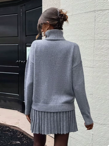 Indulge in luxury with the Margot Knit Blend Set. Elevate your style with this high collar, solid color pullover set for women. The long sleeve combines effortlessly with the elegant casual skirts for a refined and sophisticated look.