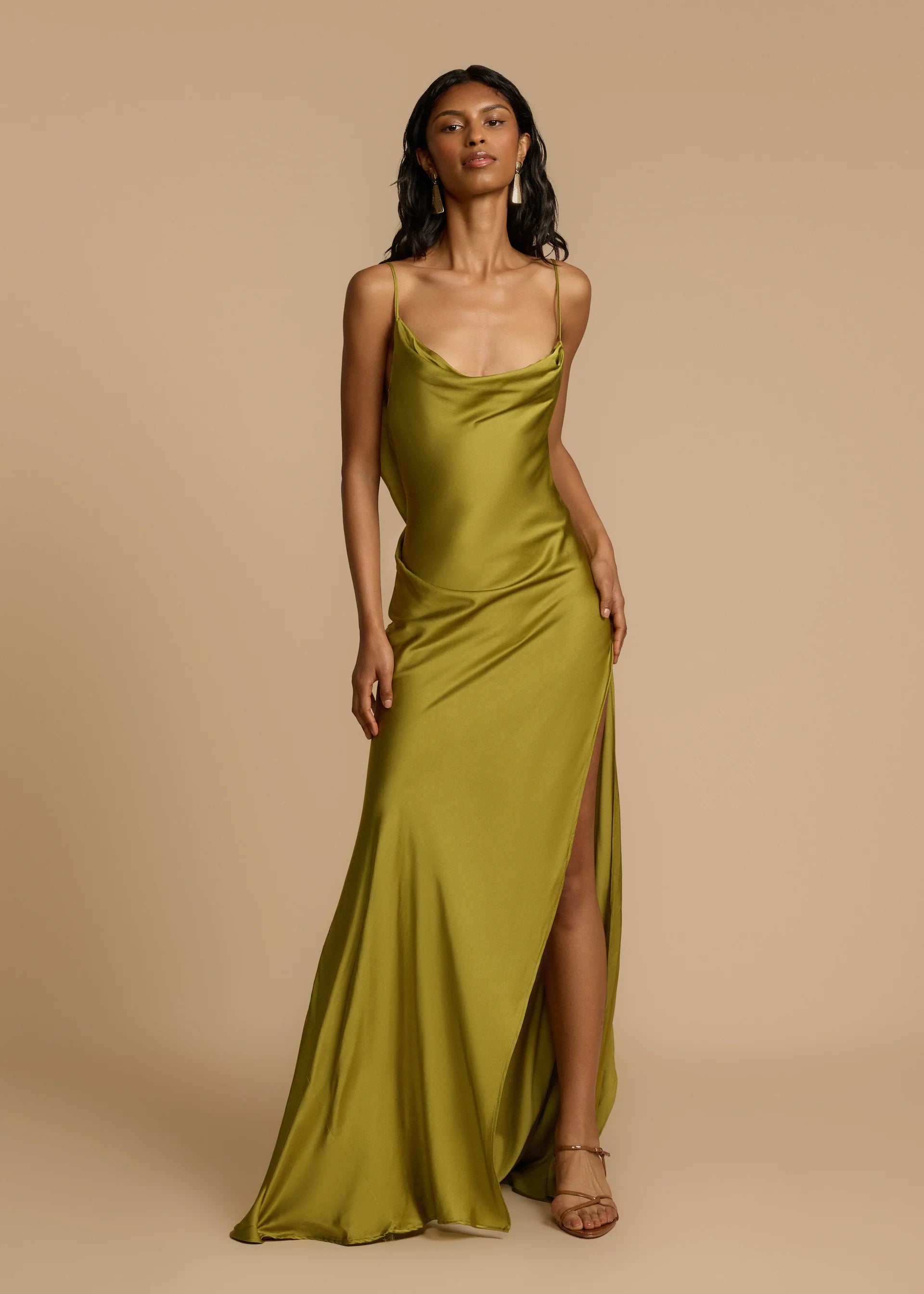 Looking for a dress that combines boldness and elegance? Look no further than the Odessa Dress! With subtle tucks at the side hip for structure and harmony, delicate spaghetti straps and a daring thigh-high slit, this dress is tailored to captivate. The asymmetrical deep V back and cascading satin details add the perfect finishing touches. Take a risk and stand out in the Odessa Dress.