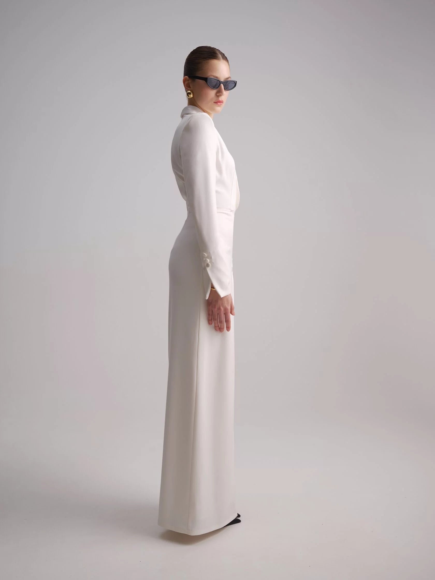 Elevate your style with the Myra Maxi Dress. This wrap-style smocked dress features a luxurious satin collar, cuffs and button detailing, exuding sophistication and elegance. Perfect for any occasion, this dress effortlessly combines comfort and style for a timeless look.